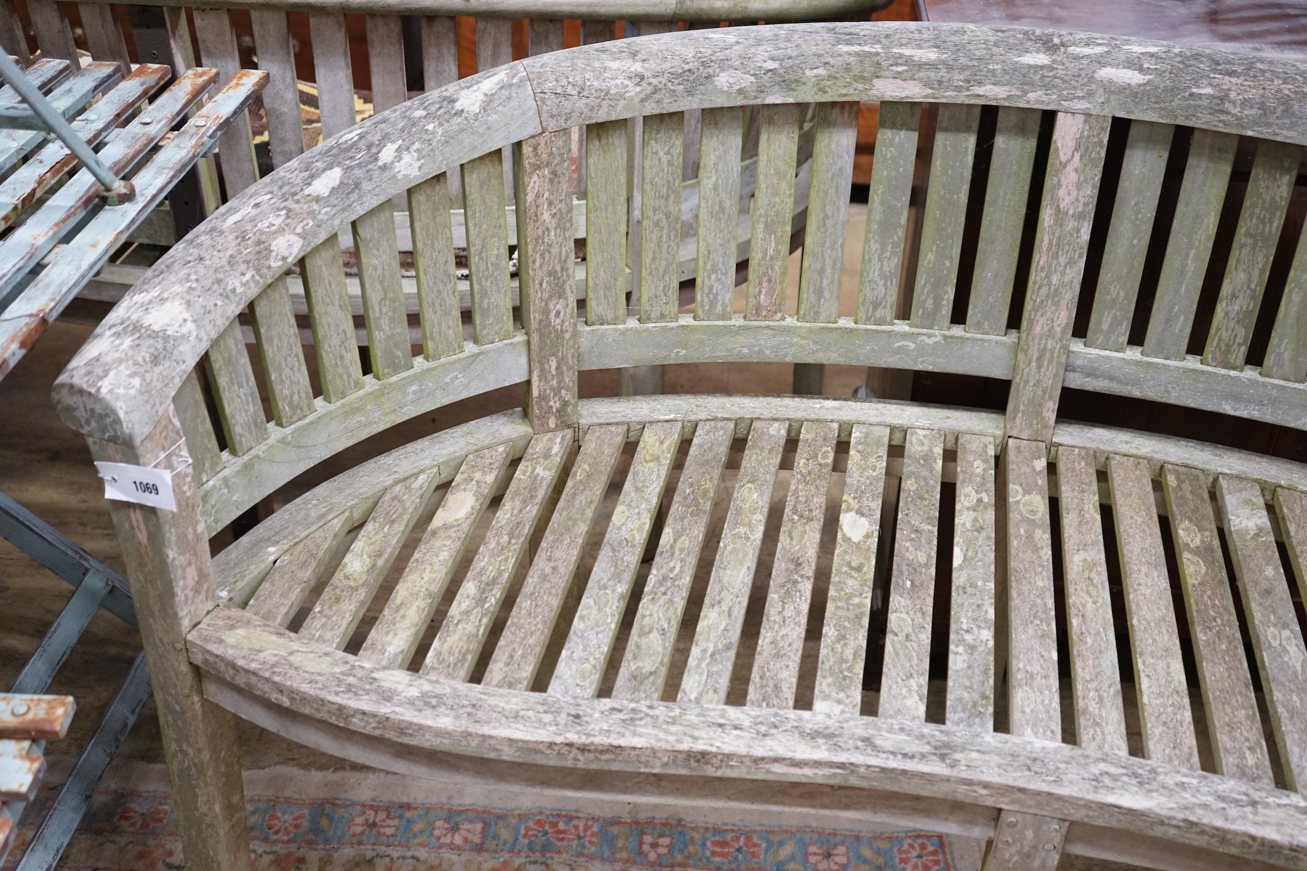 A weathered teak garden banana bench, length 160cm, depth 50cm, height 85cm